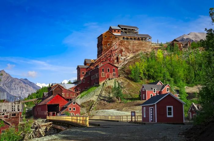 Reddish-brown structures perched on a hillside.