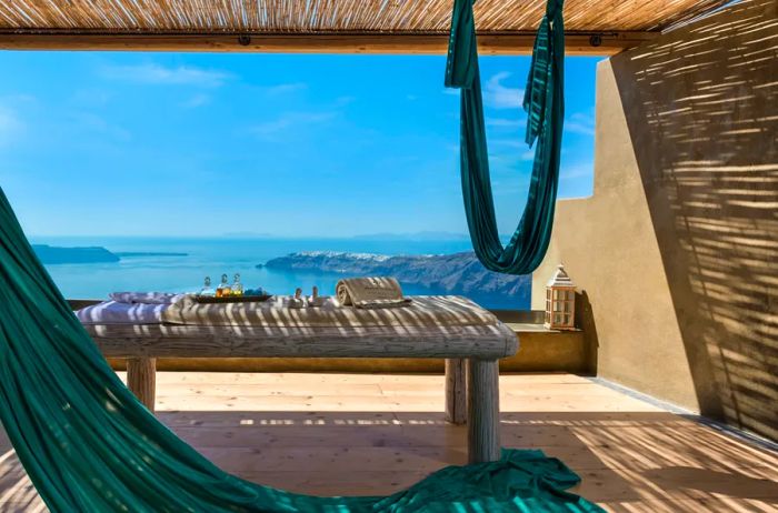 An outdoor deck at Kallos Spa within the Andronis Concept Wellness Resort, shaded and offering distant views of the Greek islands.