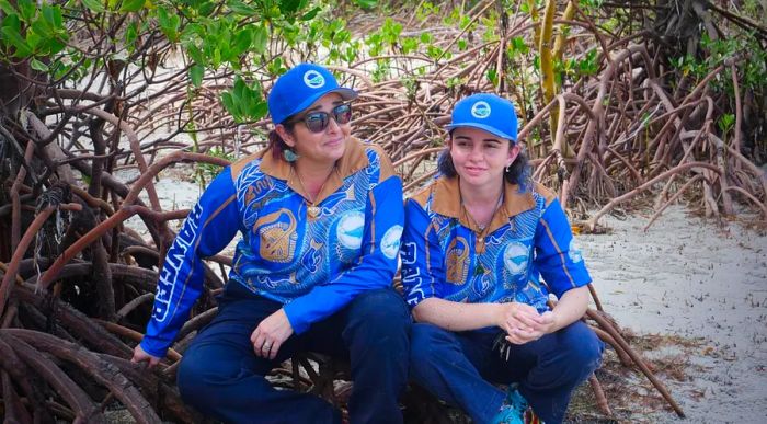 Larissa Hale (L) and her daughter Leilani, clad in ranger attire, take a break on the beach at Archer Point.