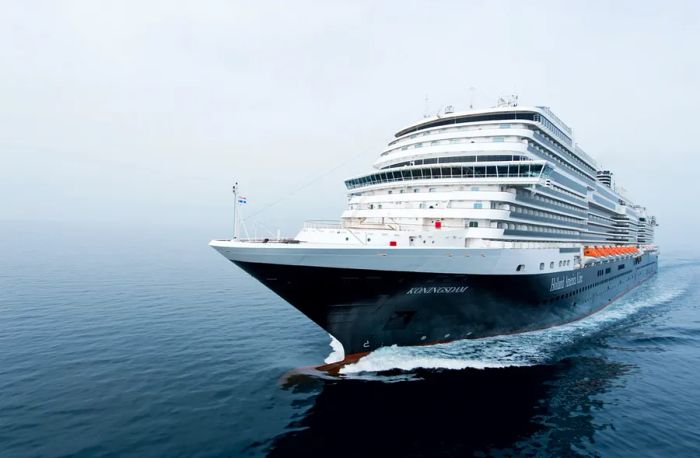 A white cruise ship gliding through the water.