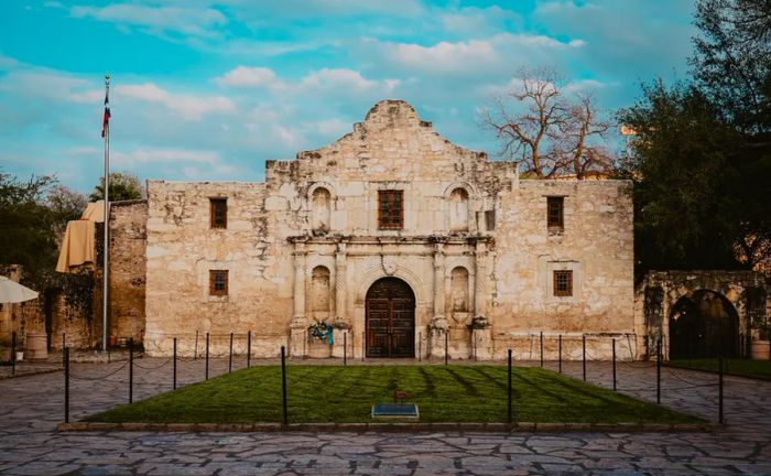 Facade of the Alamo, featuring a small green plaza in front