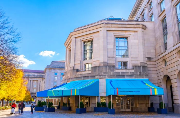 The main entrance of the National Children's Museum, featuring vibrant blue awnings