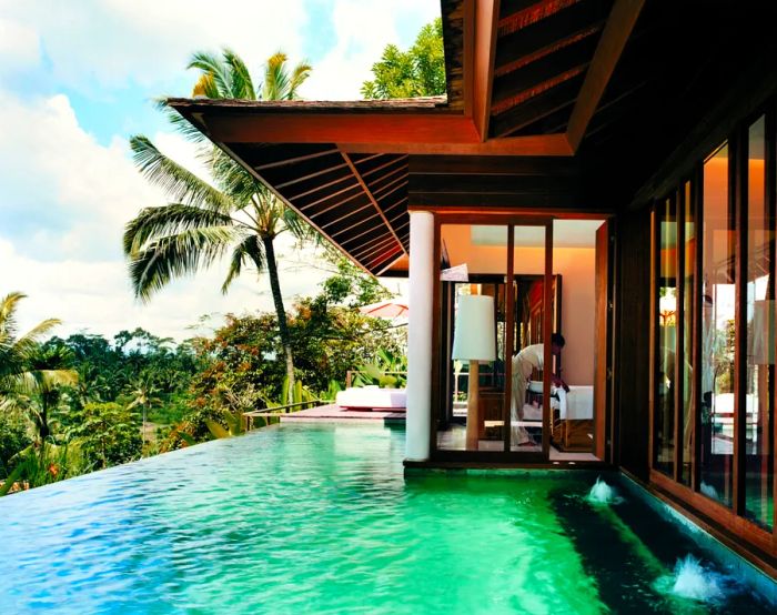 The exterior of a villa at Como Shambhala Estate features a private infinity pool and breathtaking views of the surrounding jungle.