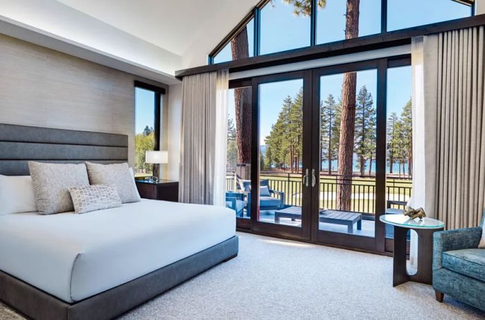 Interior view of a guest room at Edgewood Tahoe Resort featuring a high ceiling and large windows.