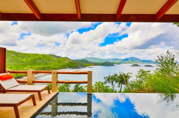 A villa at Casa Chameleon features a covered deck with a private plunge pool surrounded by lounge chairs.