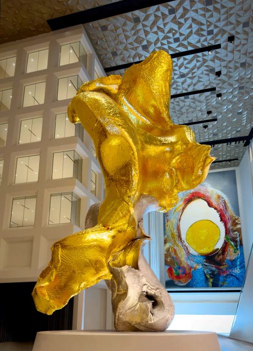 A striking gold abstract sculpture by Urs Fischer, titled 