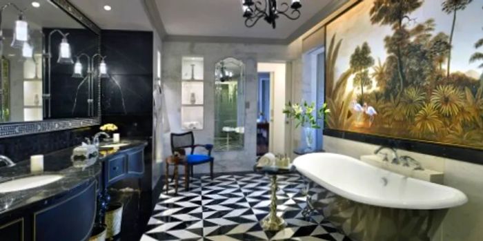 The Raffles Oasis Suite features a clawfoot soaking tub and striking black-and-white tiled floors.