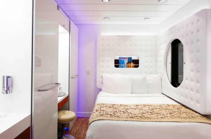 A stylish white studio cabin designed for solo travelers aboard NCL's Pride of America cruise ship.