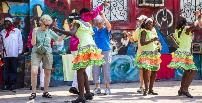 A vibrant image of travelers enjoying salsa lessons in Cuba.