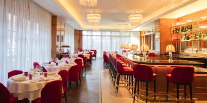 Brasserie Fouquet's boasts a vibrant decor with red chairs and an elongated black marble bar.