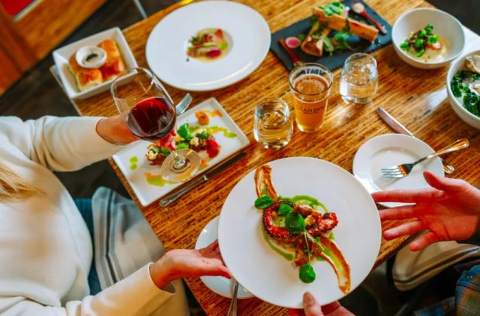 Two diners enjoying a meal at Gravity Haus Truckee-Tahoe's Stella restaurant.