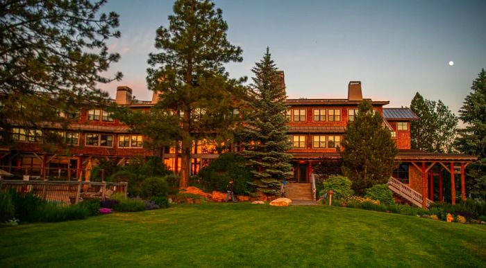 The grounds of Sun Mountain Lodge are adorned with evergreen trees.