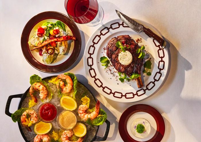 An aerial view displays a variety of dishes from Bricks and Horses, including steak and shrimp.