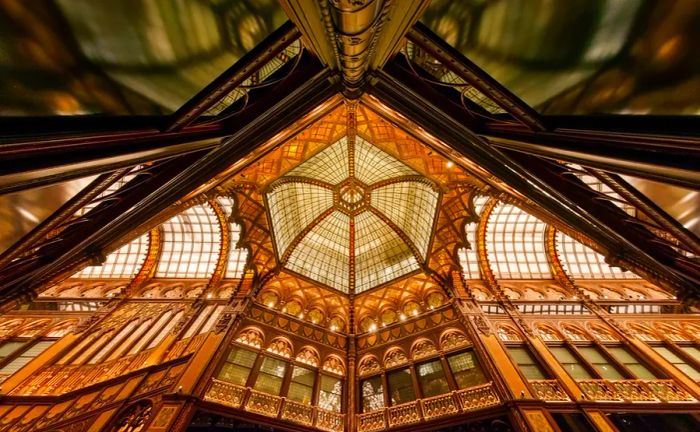 A stunning photograph capturing the grand glass ceiling of the Párisi Passage within the Parisi Udvar building in Hungary