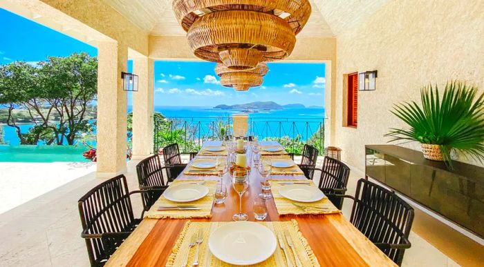 Outdoor dining at Villa One offers stunning views of the Caribbean Sea.