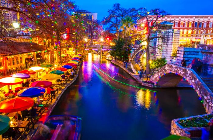 A winter evening at the River Walk in San Antonio, where colorful lights shimmer on the water.