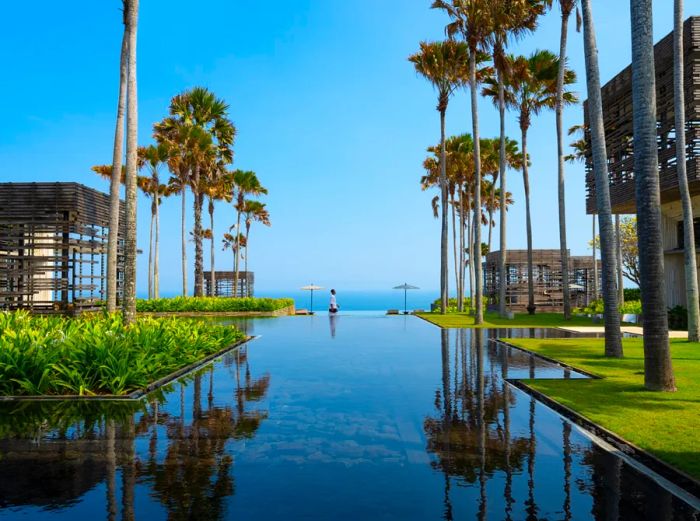 The lobby of Alila Villas Uluwatu features a spacious reflecting pool and stunning views of the sea.