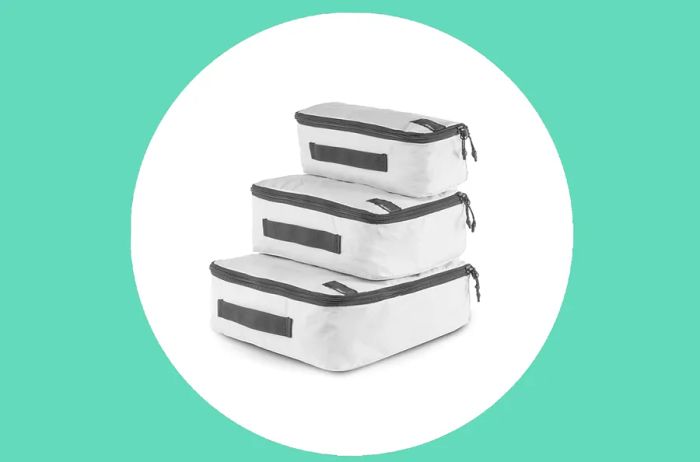 Arctic White Matador Packing Cube Set featuring three pieces in varying sizes, complete with black zippers and handles.