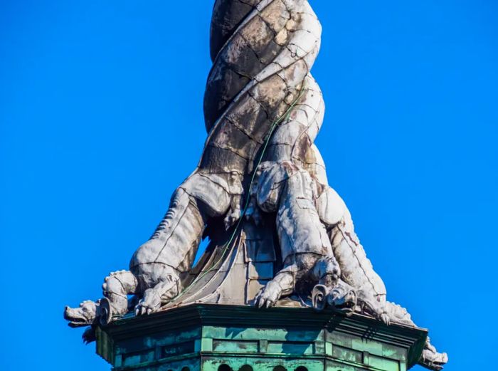 Decorative dragons with tails spiraling up the spire of the Old Stock Exchange building