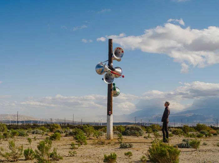 Hylozoic/Desires presents the Namak Nazar sculpture, which features a telephone pole adorned with loudspeakers.