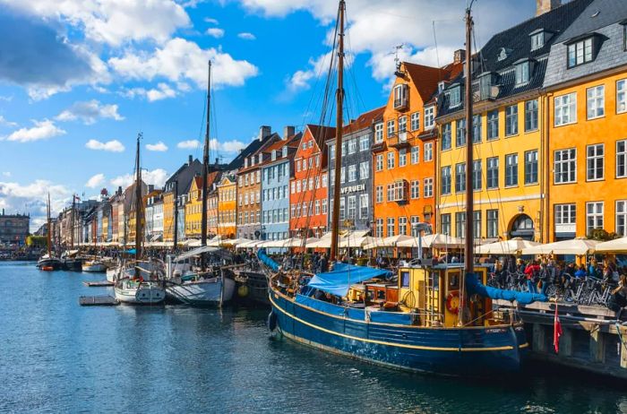 Vibrant buildings frame a canal in the famous Nyhavn district of Copenhagen.