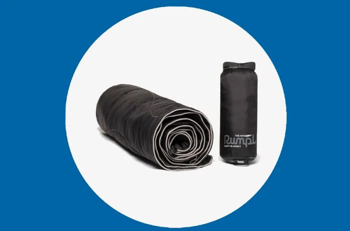 Black Rumpl blanket, rolled up and stored in its travel sack