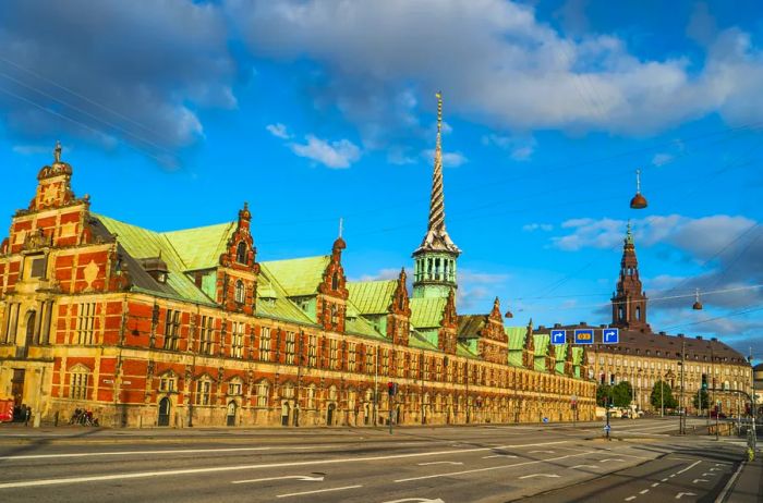 The Old Stock Exchange in Copenhagen, prior to the fire, showcasing its distinctive spiral spire adorned with dragons entwined around its base.