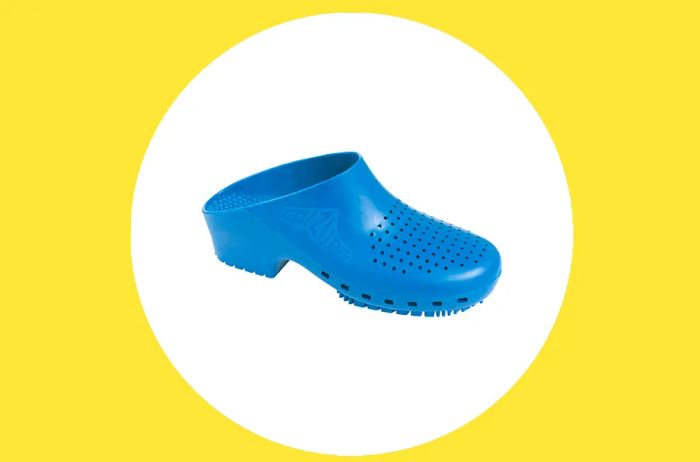 Blue Calzuro clog featuring ventilation holes on a white circle against a yellow backdrop