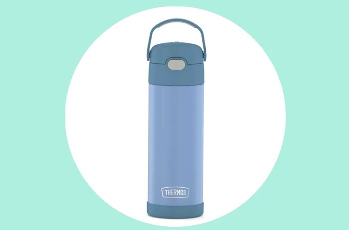 Light blue Thermos Funtainer water bottle against a green background