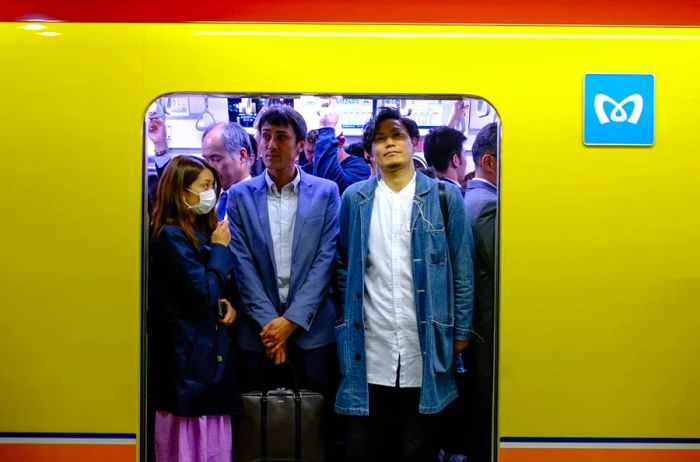 Passengers packed tightly in a Tokyo subway car