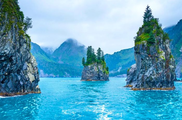 Three distinctive spires rise from the waters of Kenai Fjords National Park.