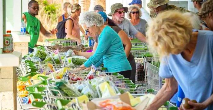 On October 4, residents collect free perishable food items at a Publix in Pine Island, Florida.