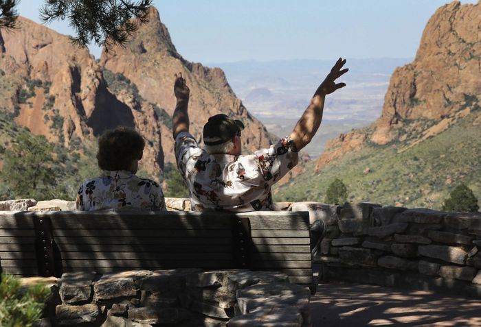 A couple enjoys the breathtaking view at the Chisos Basin in Big Bend National Park. (Photo credit: John Moore/Getty Images)