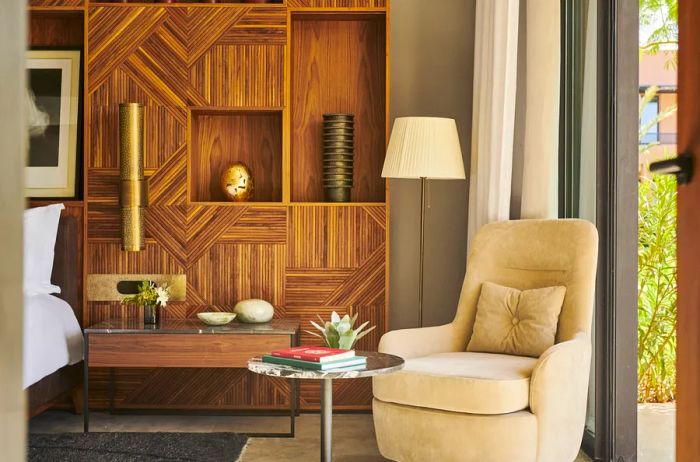 This guest room boasts a cozy seating area complemented by stylish wooden shelving.