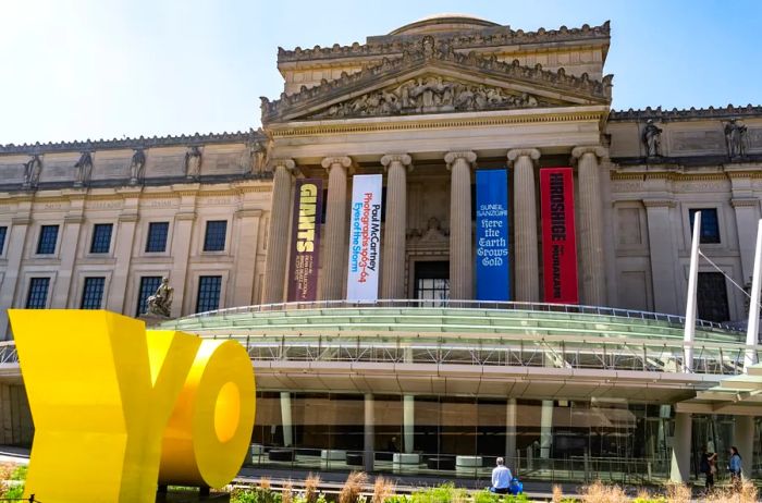 Large plastic yellow letters spelling Y-O outside the Brooklyn Museum.