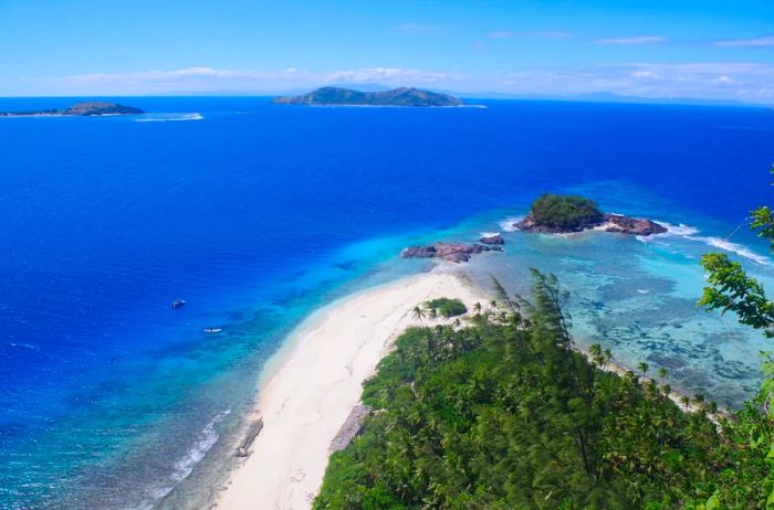 Aerial view showcasing the deserted beach at the tip of the island