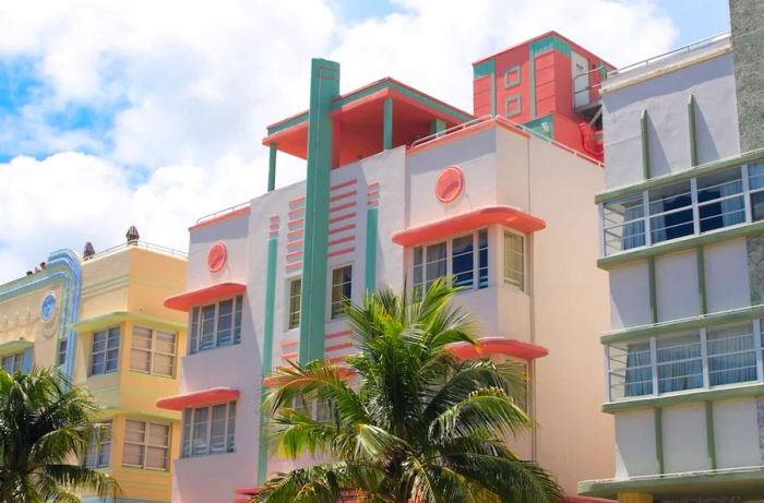 Art deco buildings in shades of pink and green, surrounded by similar architectural designs