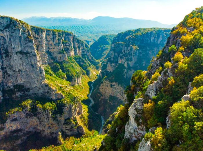 Aerial view showcasing a gorge surrounded by lush, green mountains.