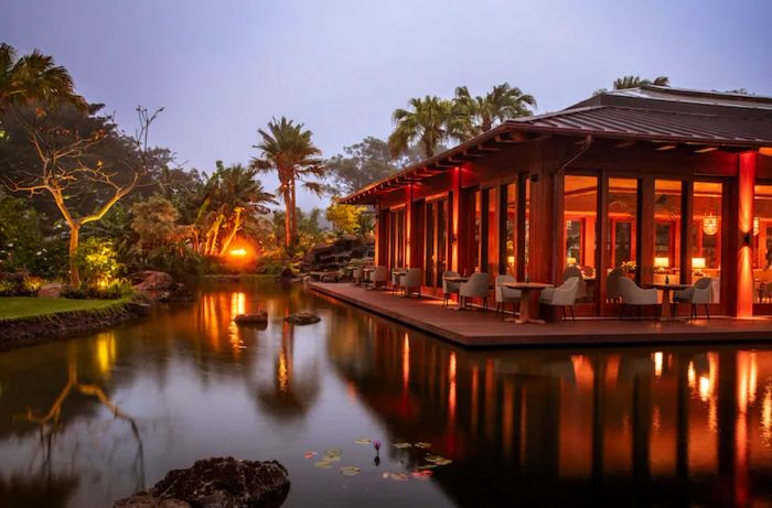 The exterior of Sensei Lānaʻi, adjacent to the pool during twilight hours.