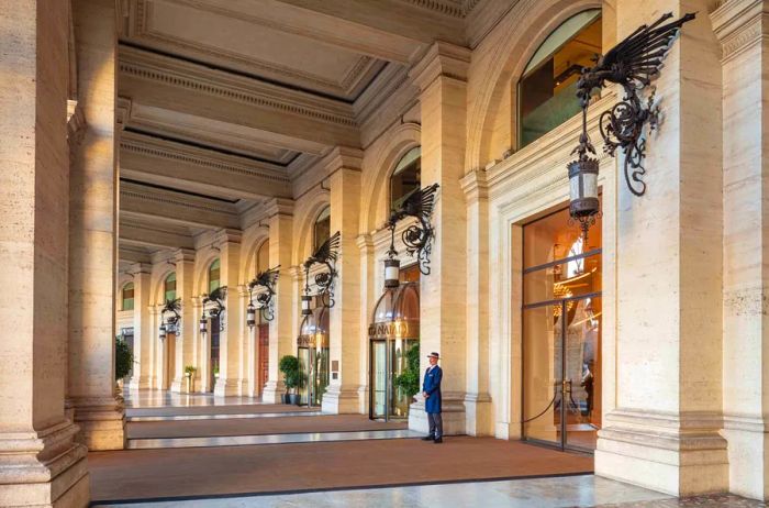 A doorman stands in stark contrast to the grandeur of the Anantara Palazzo Naiadi hotel’s entrance.