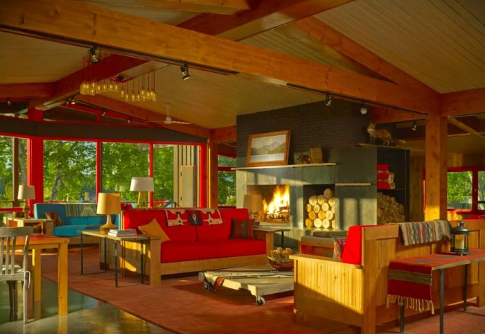 The Lake House lobby at High Peaks Resort features cozy red sofas near a welcoming fireplace.