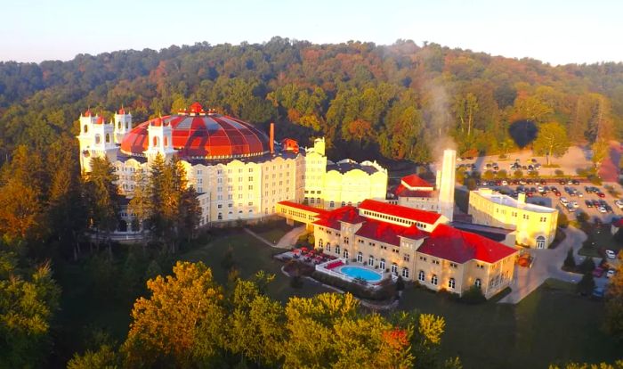 An aerial view showcasing the vast French Lick Resort nestled within southern Indiana's Hoosier National Forest.