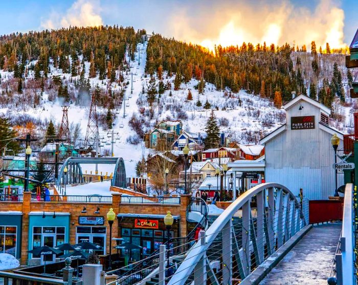 Footbridge leading to a ski resort, featuring a chairlift and a mountain backdrop at Park City.