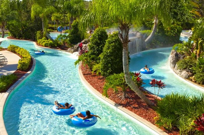 Guests float leisurely in inner tubes along the lazy river pool at the Hilton Orlando hotel