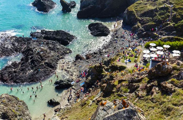 The Lizard Peninsula, featuring people on a rocky beach, seen from above