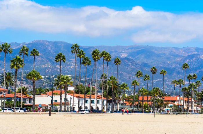 The picturesque city of Santa Barbara is framed by mountains and dotted with palm trees.