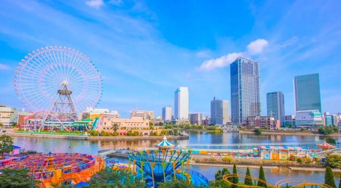 A view of Yokohama showcases an amusement park and towering skyscrapers along the waterfront.