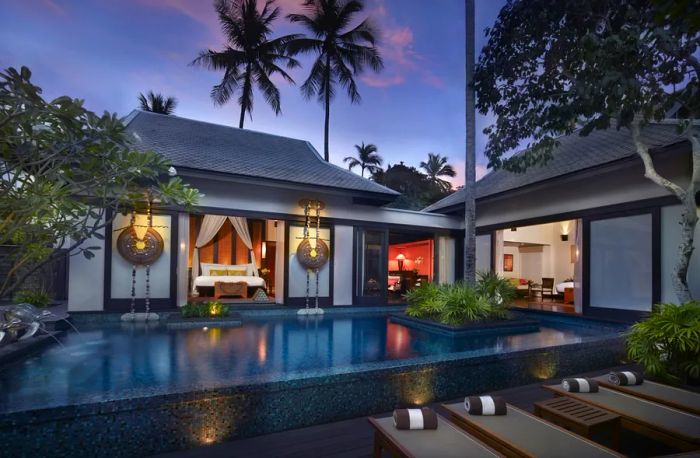 The exterior of a villa at Anantara Mai Khao Phuket Villas includes a private pool, bedroom, and separate living area.