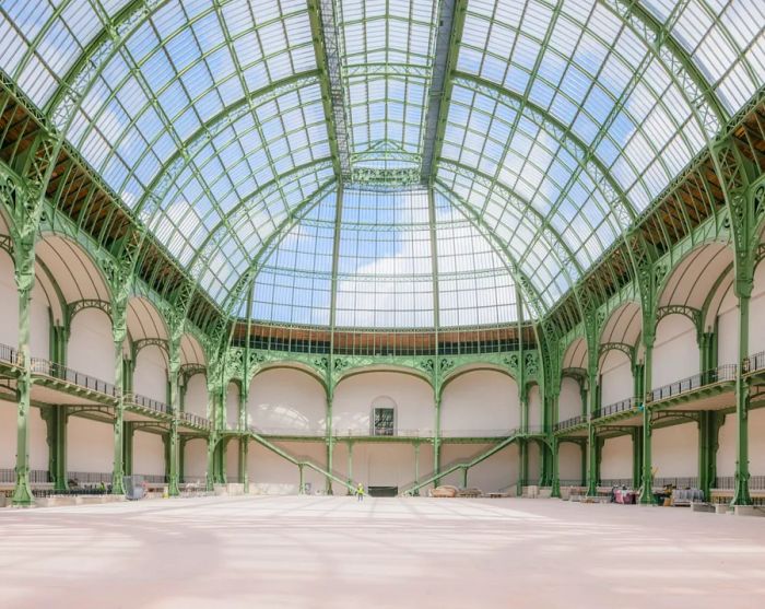 The spacious interior of the Grand Palais, featuring a second-story balcony along three walls.