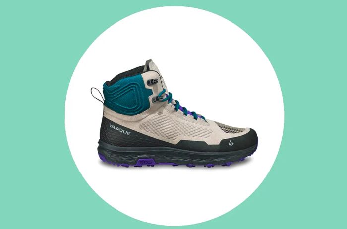 Side View of a Women's Vasque Hiking Boot in Light Gray, Teal, and Black